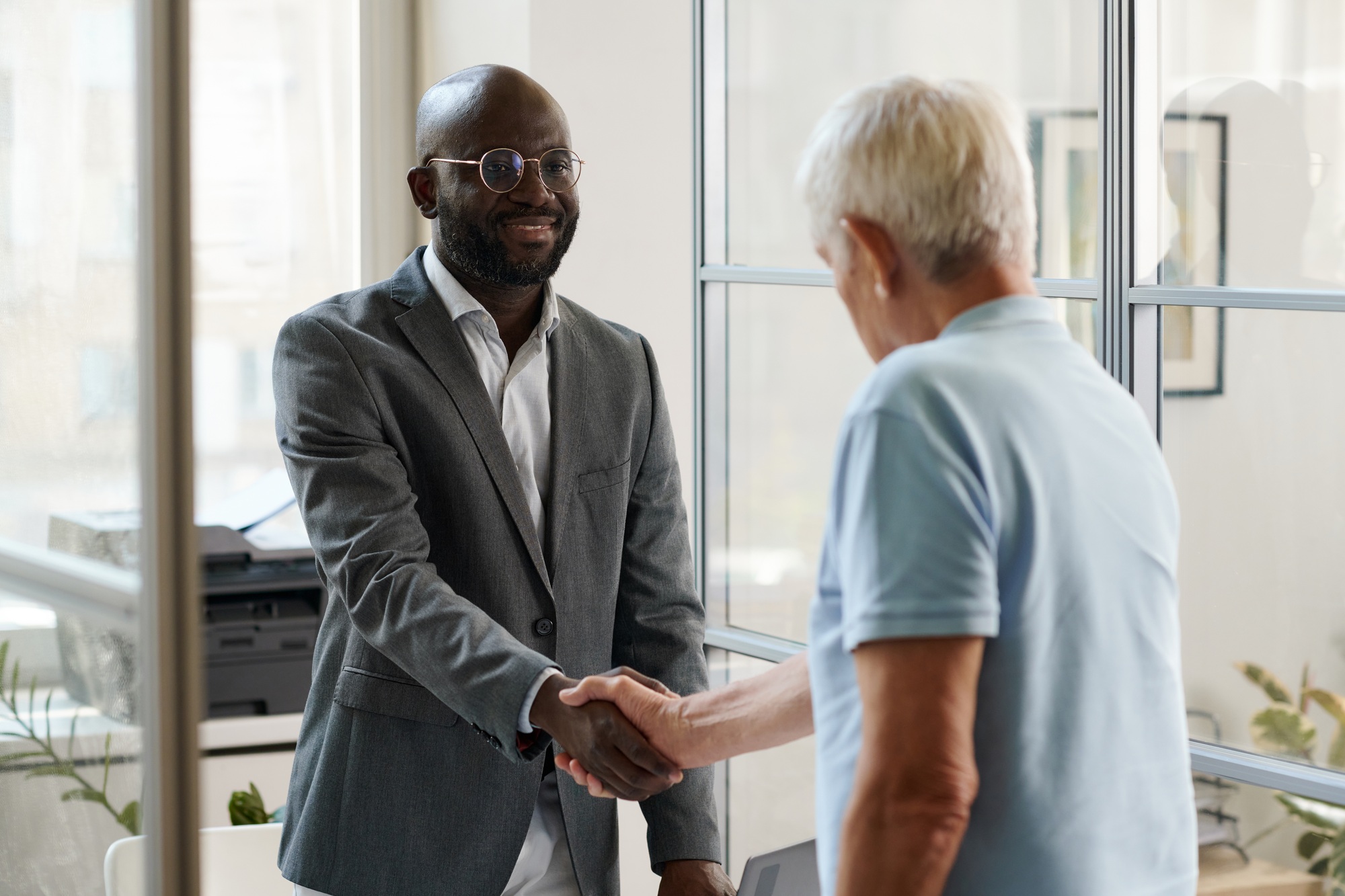 Lawyer greeting client in office